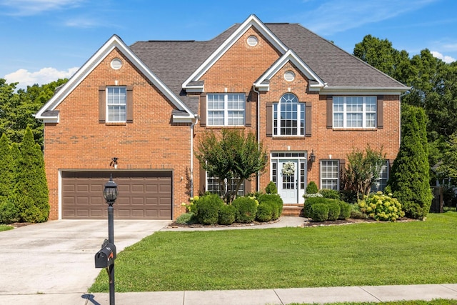 7767 Lynnle Way, Hixson, TN 37343 - view of front of home featuring a front lawn, concrete driveway, brick siding, and an attached garage