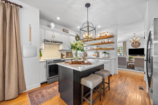 7767 Lynnle Way, Hixson, TN 37343 - kitchen featuring appliances with stainless steel finishes, a chandelier, under cabinet range hood, light countertops, and light wood-type flooring