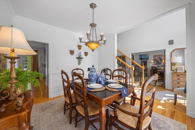 7767 Lynnle Way, Hixson, TN 37343 - dining space with stairs, light wood-style flooring, a chandelier, and crown molding
