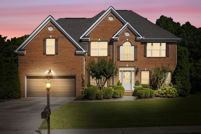 7767 Lynnle Way, Hixson, TN 37343 - view of front of property with driveway, a garage, brick siding, and a lawn