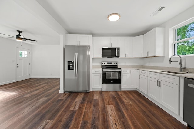 706 Mars St, Murfreesboro, TN 37130 - kitchen featuring appliances with stainless steel finishes, light countertops, dark wood-style flooring, and healthy amount of natural light