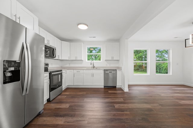 706 Mars St, Murfreesboro, TN 37130 - kitchen with stainless steel appliances, light countertops, dark wood-style flooring, and white cabinetry