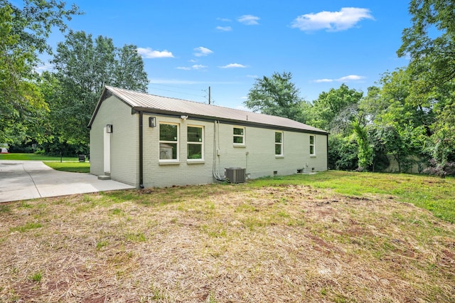 706 Mars St, Murfreesboro, TN 37130 - back of property with brick siding, a lawn, a patio, and a metal roof