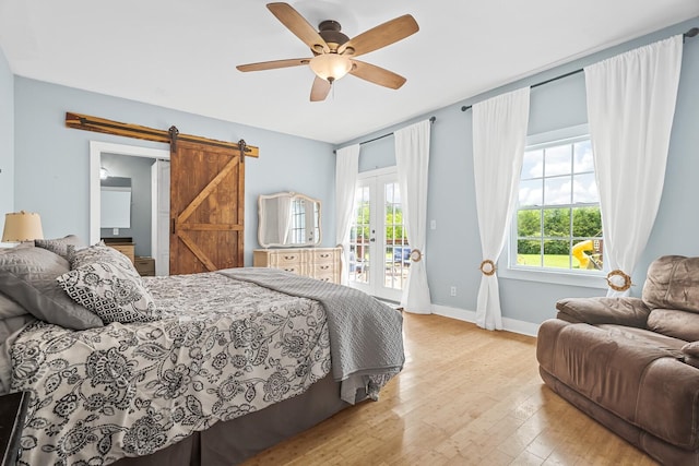 1786 Rocky Glade Rd, Eagleville, TN 37060 - bedroom with access to outside, a barn door, hardwood / wood-style flooring, french doors, and ceiling fan