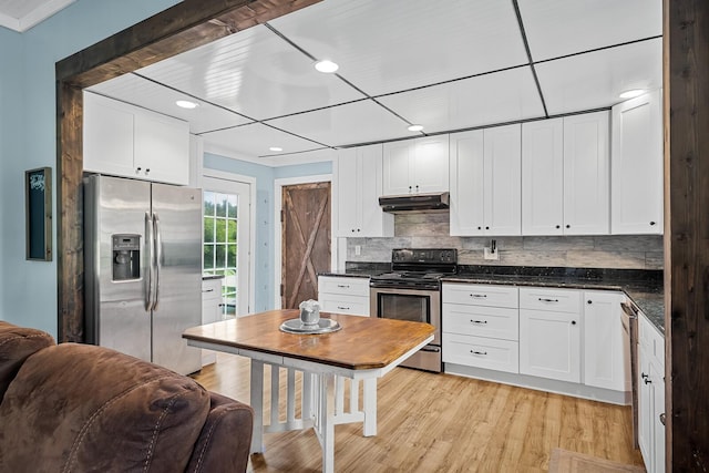 1786 Rocky Glade Rd, Eagleville, TN 37060 - kitchen with appliances with stainless steel finishes, under cabinet range hood, white cabinetry, decorative backsplash, and light wood-style flooring