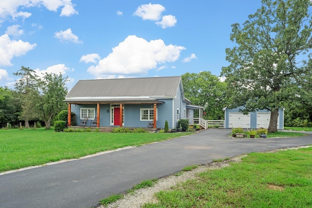 1786 Rocky Glade Rd, Eagleville, TN 37060 - view of front of house featuring a garage, covered porch, a metal roof, a front lawn, and an outdoor structure