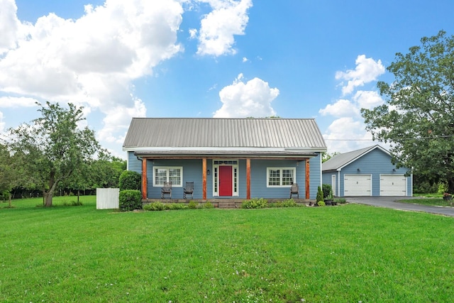 1786 Rocky Glade Rd, Eagleville, TN 37060 - view of front of property featuring covered porch, a detached garage, a front lawn, a metal roof, and an outbuilding