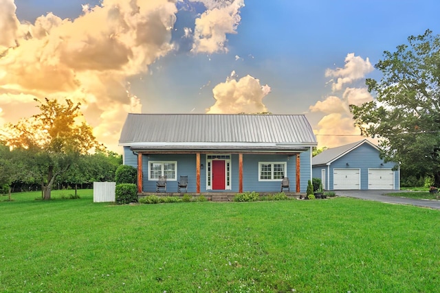 1786 Rocky Glade Rd, Eagleville, TN 37060 - view of front of property featuring covered porch, a garage, a metal roof, a front yard, and an outdoor structure