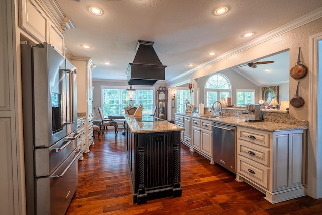130 Fairway Cir, Loretto, TN 38469 - kitchen with appliances with stainless steel finishes, cream cabinets, ornamental molding, plenty of natural light, and light stone counters
