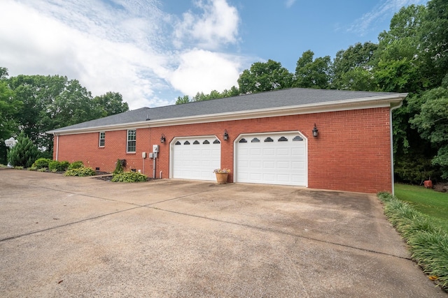 130 Fairway Cir, Loretto, TN 38469 - view of side of home with brick siding, concrete driveway, and an attached garage
