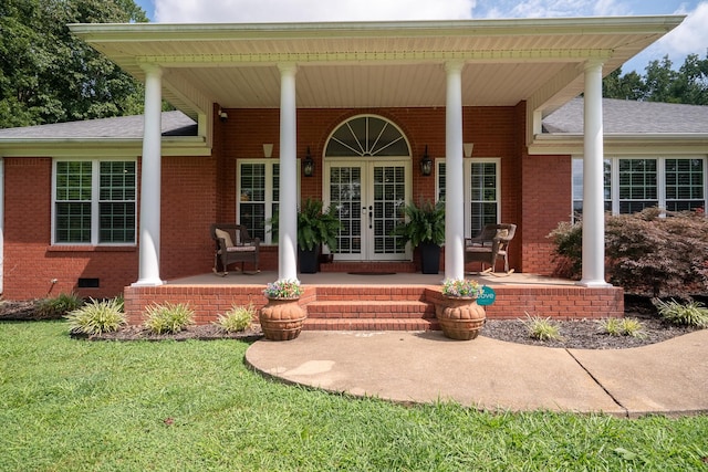 130 Fairway Cir, Loretto, TN 38469 - view of exterior entry featuring french doors, covered porch, brick siding, and a lawn