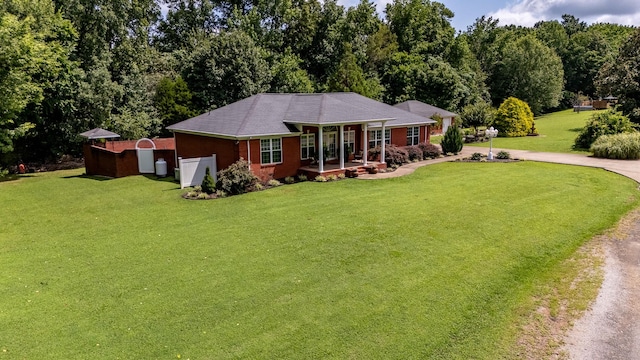 130 Fairway Cir, Loretto, TN 38469 - view of front of property with driveway, a front yard, and a storage shed