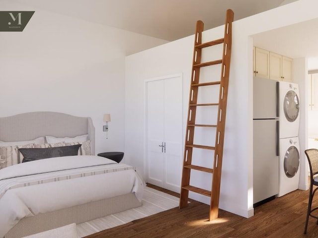 1572 Madison St, Chattanooga, TN 37408 - bedroom with estacked washer and dryer, freestanding refrigerator, and wood finished floors