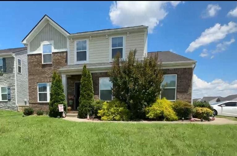 2221 Pearwick Ct, Murfreesboro, TN 37127 - view of front of property featuring a front yard, board and batten siding, and brick siding