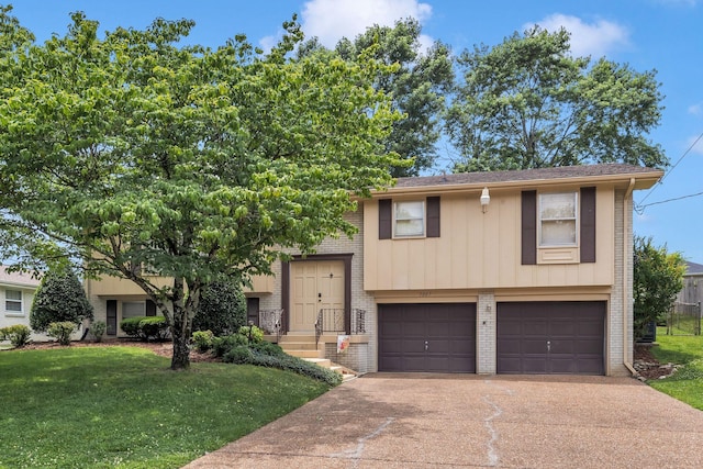 5007 Olivia Dr, Antioch, TN 37013 - view of front of house featuring brick siding, driveway, a garage, and a front lawn