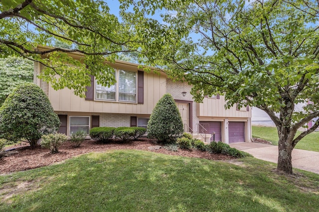 5007 Olivia Dr, Antioch, TN 37013 - raised ranch with concrete driveway, a front lawn, brick siding, and an attached garage