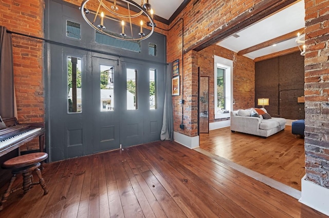 422 N Academy St, Murfreesboro, TN 37130 - foyer with wood-type flooring, a high ceiling, and brick wall