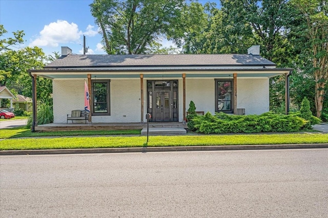 422 N Academy St, Murfreesboro, TN 37130 - view of front of home with a chimney, brick siding, and covered porch