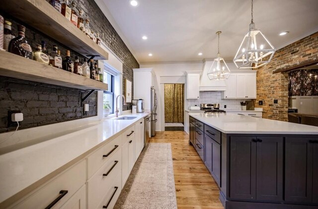 422 N Academy St, Murfreesboro, TN 37130 - kitchen featuring open shelves, appliances with stainless steel finishes, a chandelier, white cabinets, and light countertops