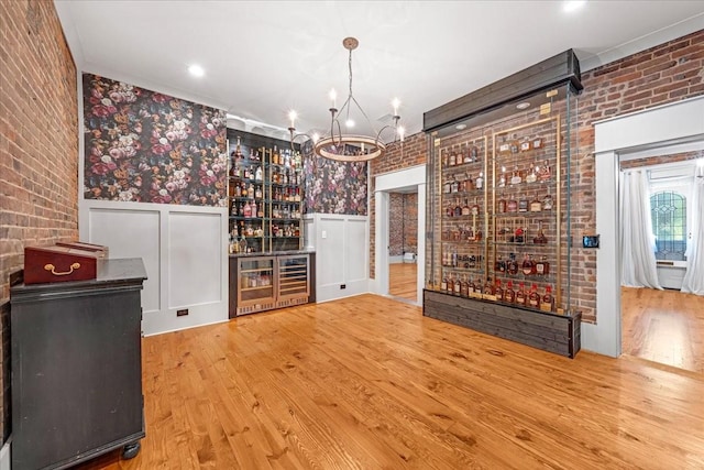 422 N Academy St, Murfreesboro, TN 37130 - wine area featuring wood finished floors, a wainscoted wall, a chandelier, wallpapered walls, and brick wall