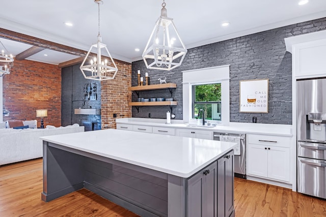 422 N Academy St, Murfreesboro, TN 37130 - kitchen with stainless steel appliances, a chandelier, a kitchen island, light countertops, and white cabinetry