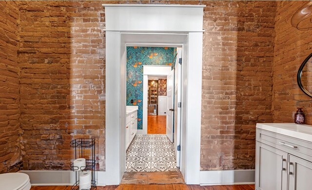 422 N Academy St, Murfreesboro, TN 37130 - bathroom featuring vanity, brick wall, and wood finished floors