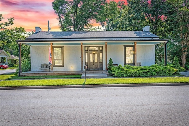 422 N Academy St, Murfreesboro, TN 37130 - view of front of house with covered porch, a chimney, and brick siding