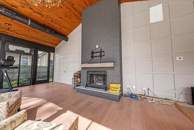 422 N Academy St, Murfreesboro, TN 37130 - unfurnished living room with high vaulted ceiling, wood finished floors, a decorative wall, a brick fireplace, and wood ceiling