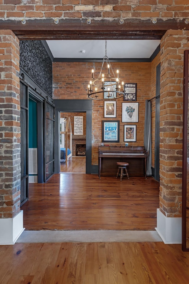 422 N Academy St, Murfreesboro, TN 37130 - dining area with a chandelier, hardwood / wood-style floors, a fireplace, and brick wall