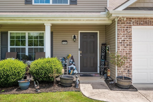 15252 Foamflower Ln, Sale Creek, TN 37373 - property entrance featuring an attached garage, brick siding, and a porch
