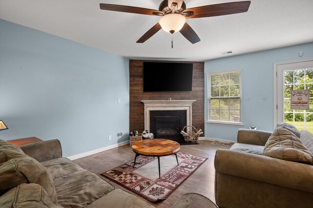 15252 Foamflower Ln, Sale Creek, TN 37373 - living area with healthy amount of natural light, a ceiling fan, a fireplace, and wood finished floors