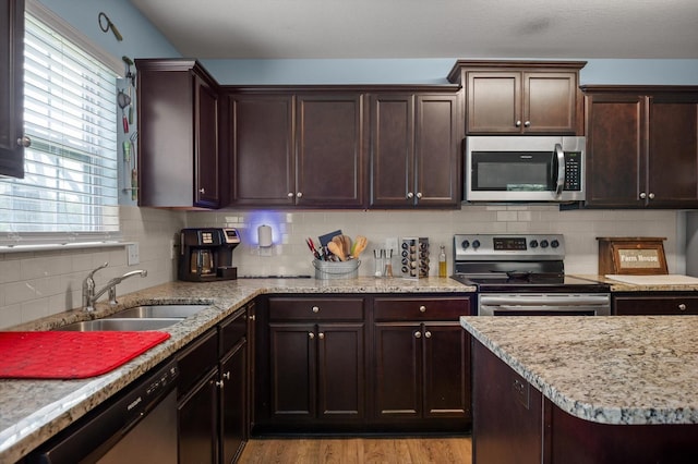 15252 Foamflower Ln, Sale Creek, TN 37373 - kitchen with stainless steel appliances, backsplash, and dark brown cabinetry