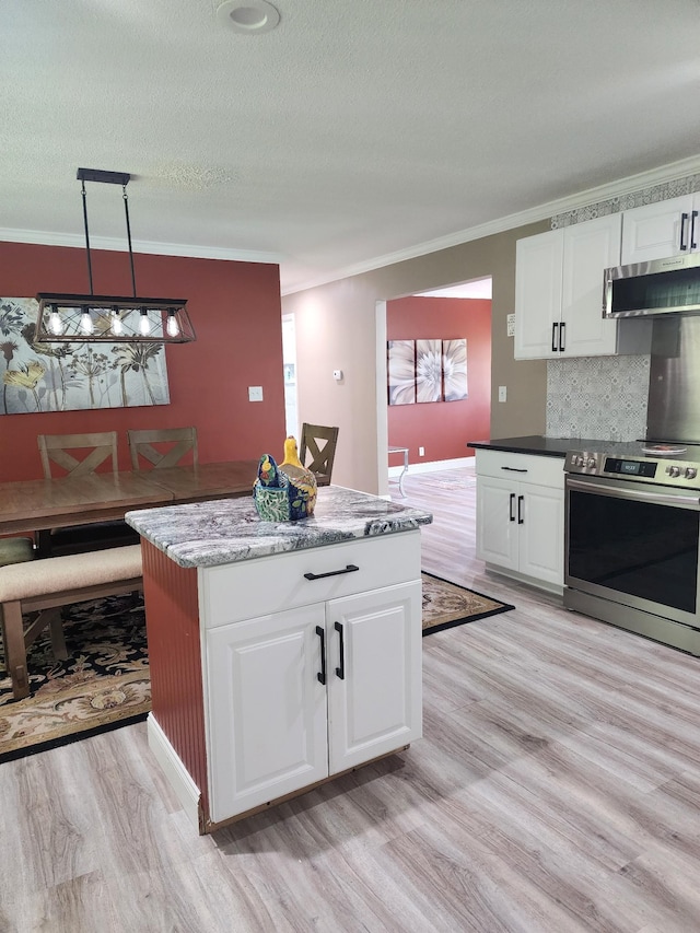 119 Horn Ave, Loretto, TN 38469 - kitchen with stainless steel appliances, ornamental molding, light wood-style floors, white cabinets, and backsplash