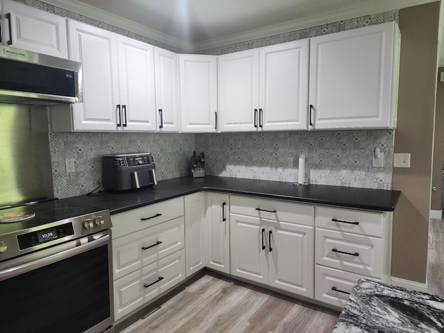 119 Horn Ave, Loretto, TN 38469 - kitchen with stainless steel appliances, light wood-style floors, white cabinets, tasteful backsplash, and crown molding