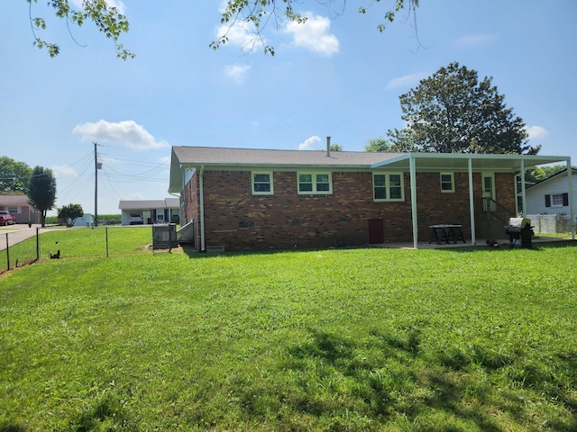 119 Horn Ave, Loretto, TN 38469 - back of property with a patio and brick siding