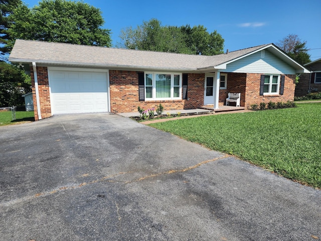 119 Horn Ave, Loretto, TN 38469 - single story home with brick siding, a garage, and driveway