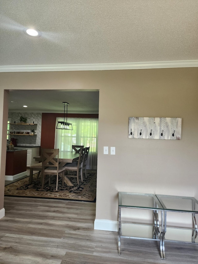 119 Horn Ave, Loretto, TN 38469 - dining area with crown molding, wood finished floors, and a textured ceiling