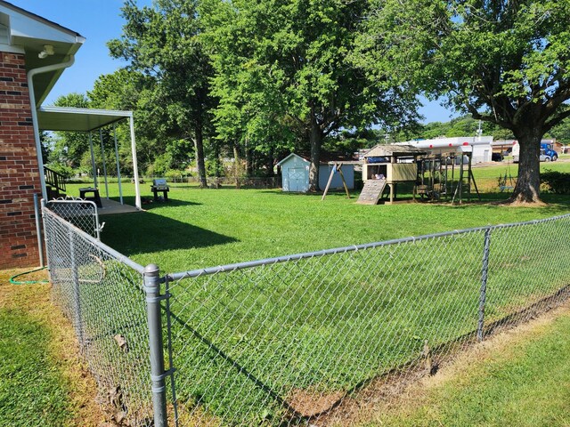 119 Horn Ave, Loretto, TN 38469 - fenced backyard with a playground and a shed