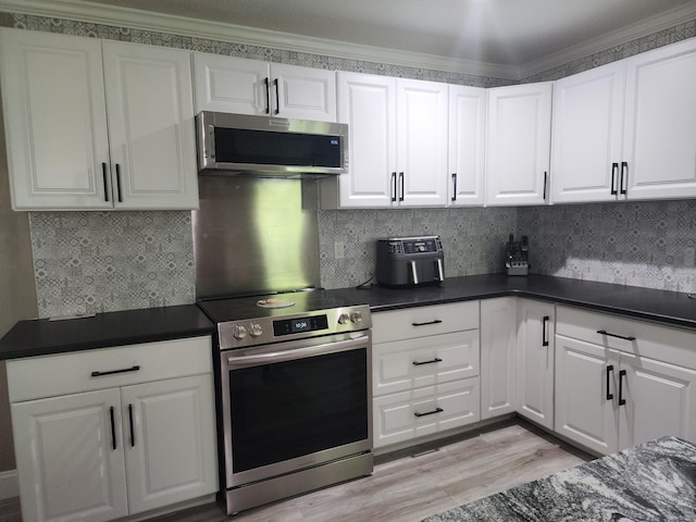 119 Horn Ave, Loretto, TN 38469 - kitchen featuring stainless steel appliances, dark countertops, light wood-type flooring, white cabinetry, and backsplash