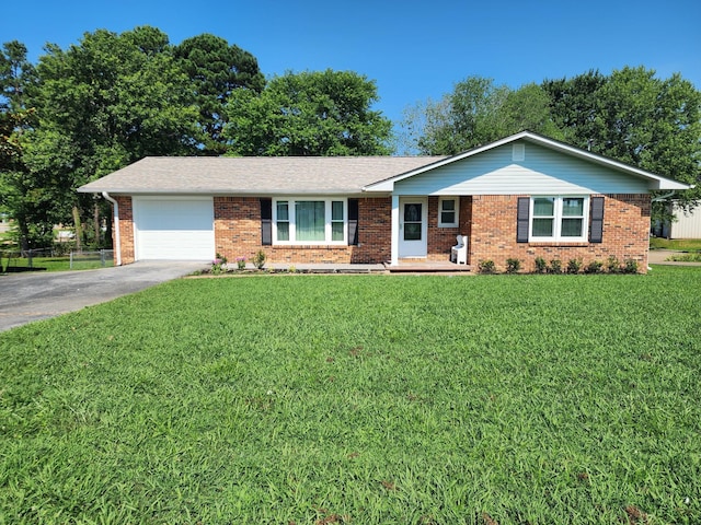 119 Horn Ave, Loretto, TN 38469 - ranch-style house with brick siding, a garage, driveway, and a front yard