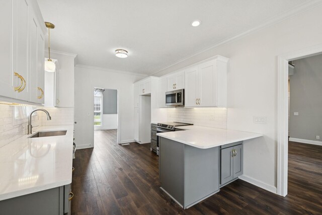 1704 Satterfield Ct, Murfreesboro, TN 37128 - kitchen featuring stainless steel microwave, a peninsula, ornamental molding, backsplash, and light countertops