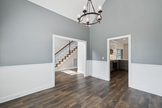 1704 Satterfield Ct, Murfreesboro, TN 37128 - unfurnished dining area featuring stairs, a chandelier, dark wood-style flooring, a high ceiling, and wainscoting