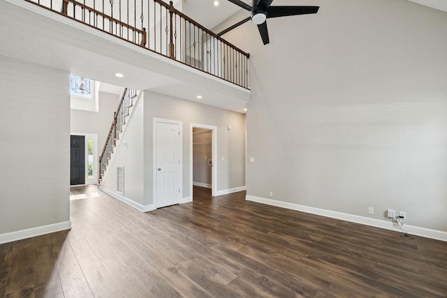 1704 Satterfield Ct, Murfreesboro, TN 37128 - unfurnished living room with a high ceiling, dark wood-style flooring, a ceiling fan, and stairs