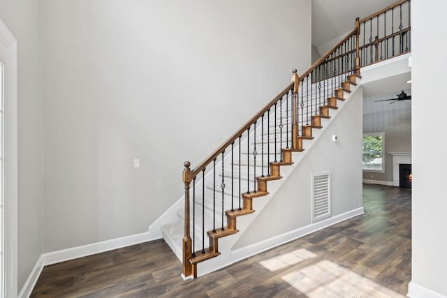 1704 Satterfield Ct, Murfreesboro, TN 37128 - stairway with wood finished floors, a ceiling fan, a high ceiling, and a warm lit fireplace