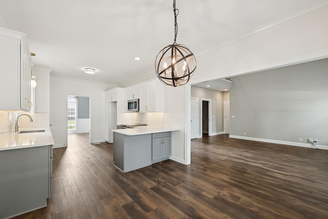 1704 Satterfield Ct, Murfreesboro, TN 37128 - kitchen with stainless steel microwave, a chandelier, tasteful backsplash, gray cabinets, and dark wood finished floors