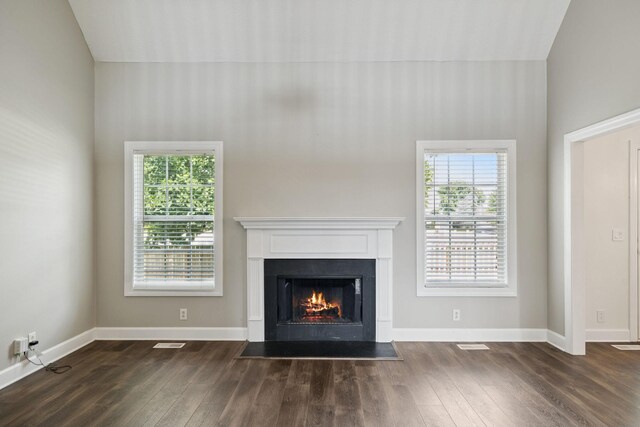 1704 Satterfield Ct, Murfreesboro, TN 37128 - unfurnished living room featuring dark wood finished floors, a lit fireplace, healthy amount of natural light, and vaulted ceiling