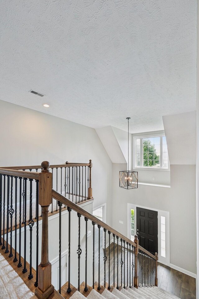 1704 Satterfield Ct, Murfreesboro, TN 37128 - stairs with a textured ceiling, a chandelier, wood finished floors, and recessed lighting
