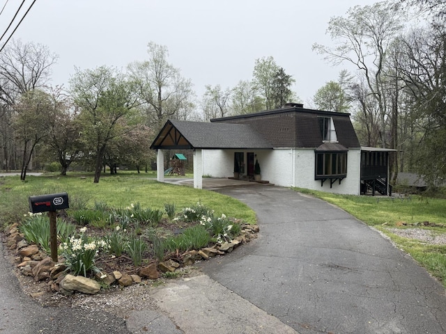 236 N Carolina Ave, Sewanee, TN 37375 - view of front of house with driveway, a front yard, a shingled roof, and a carport
