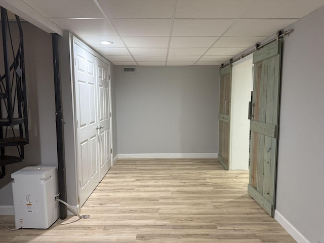 236 N Carolina Ave, Sewanee, TN 37375 - hallway featuring a barn door, light wood-type flooring, a drop ceiling, and recessed lighting