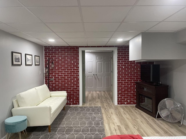 236 N Carolina Ave, Sewanee, TN 37375 - living area with a paneled ceiling, brick wall, and wood finished floors